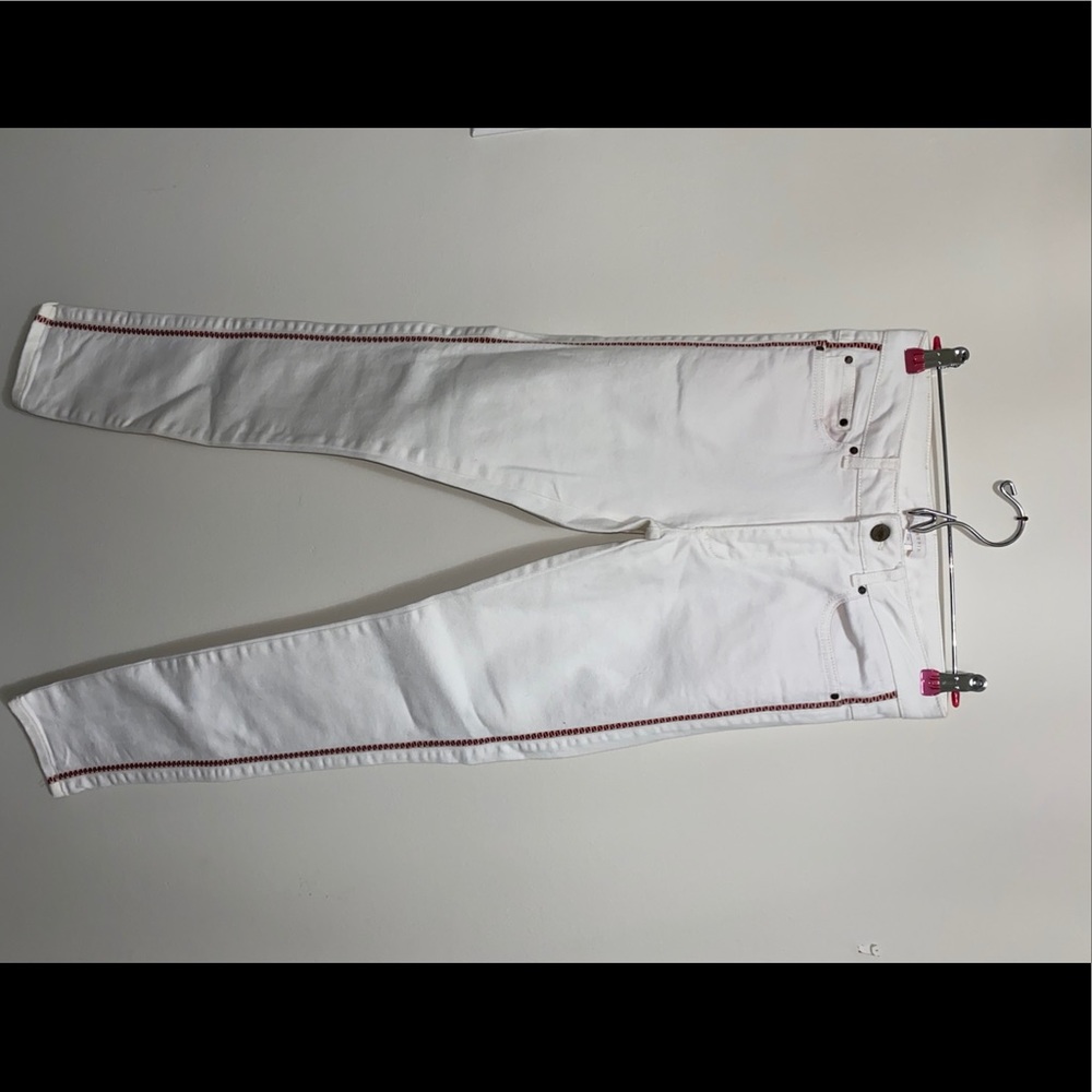 whites jeans with red detailing on the sides